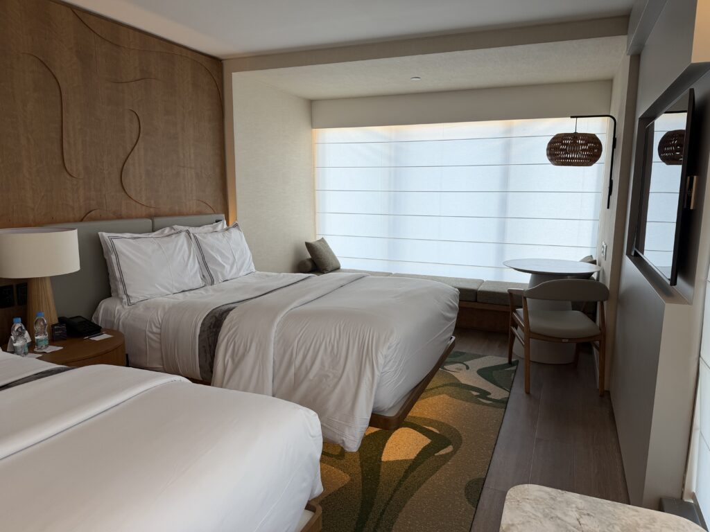 a room with two beds and a window