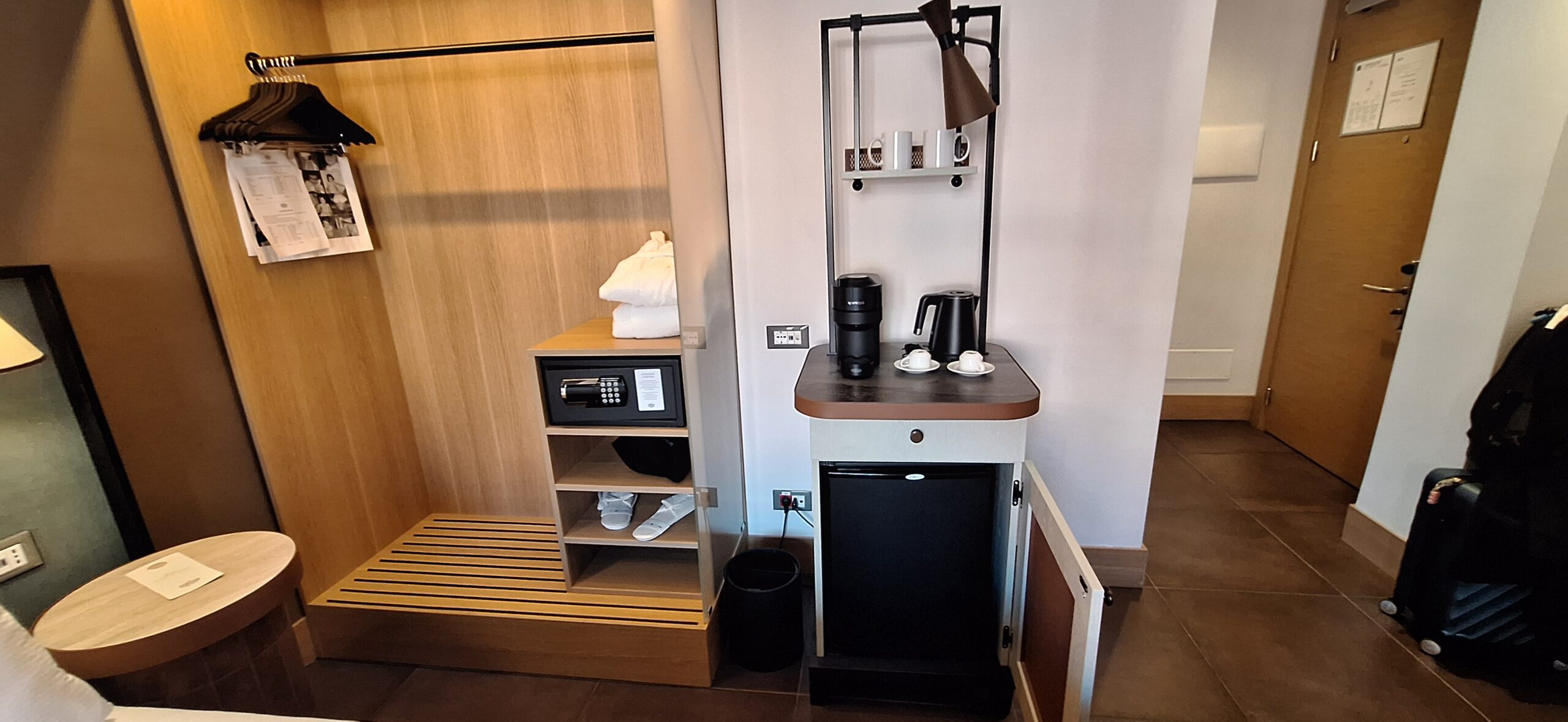 a small refrigerator with a coffee maker and a small shelf
