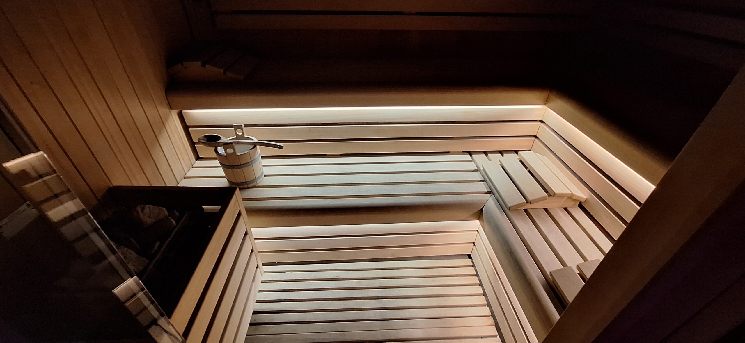 a wooden bench with a bucket and a bucket on it