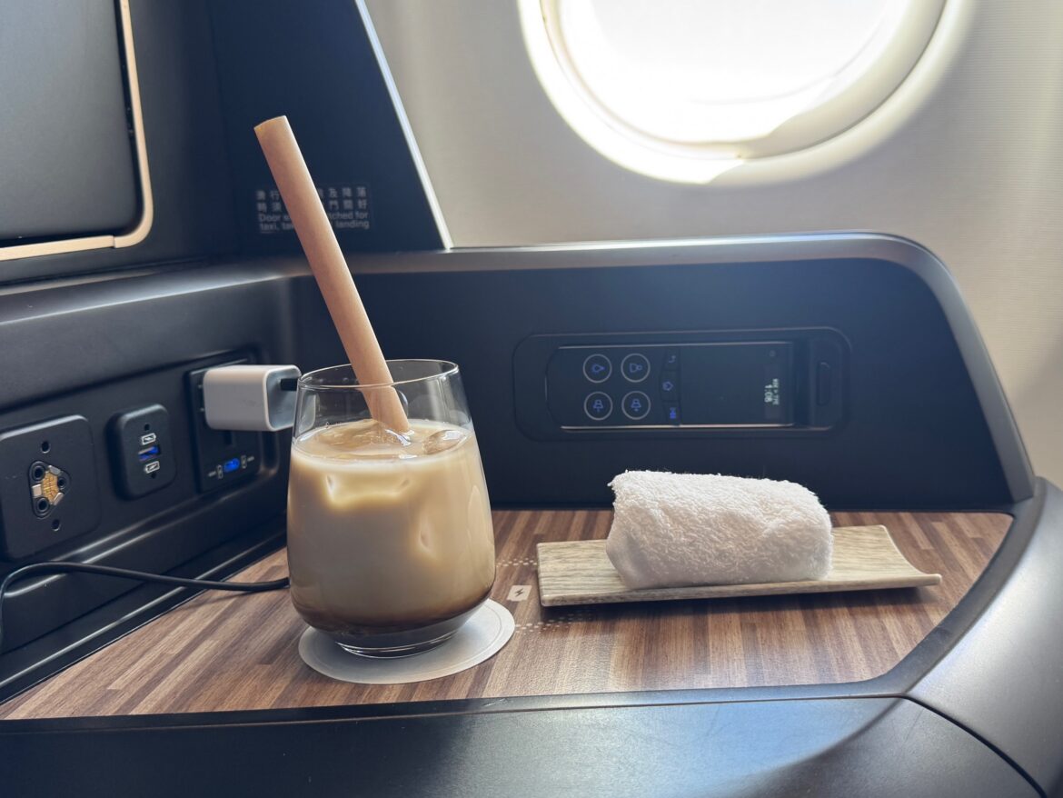 a glass with a straw and a towel on a table
