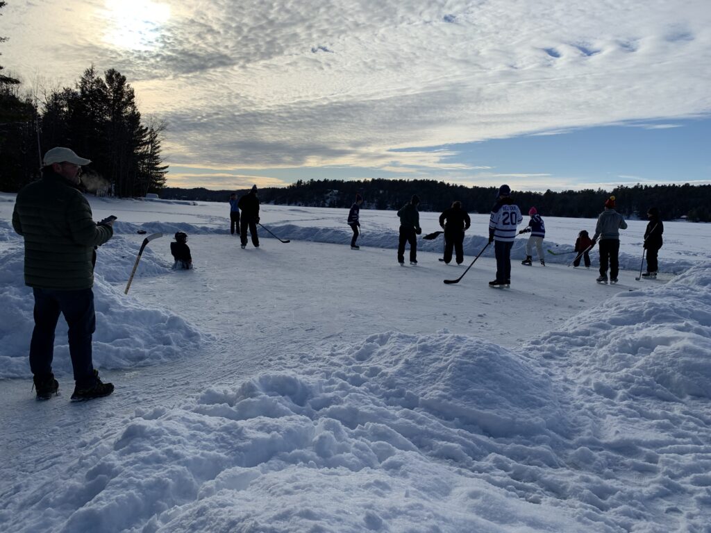a group of people playing hockey in the snow
