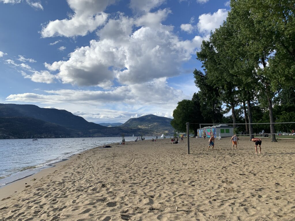a beach with people playing volleyball