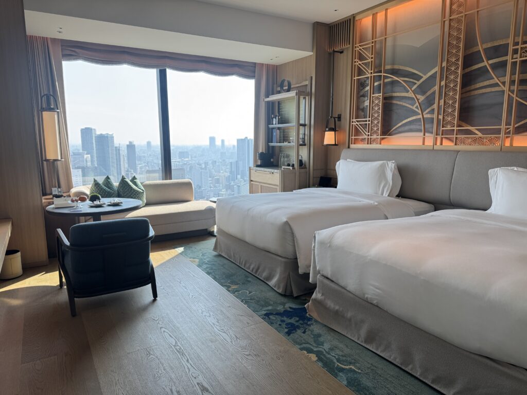 a room with two beds and a large window