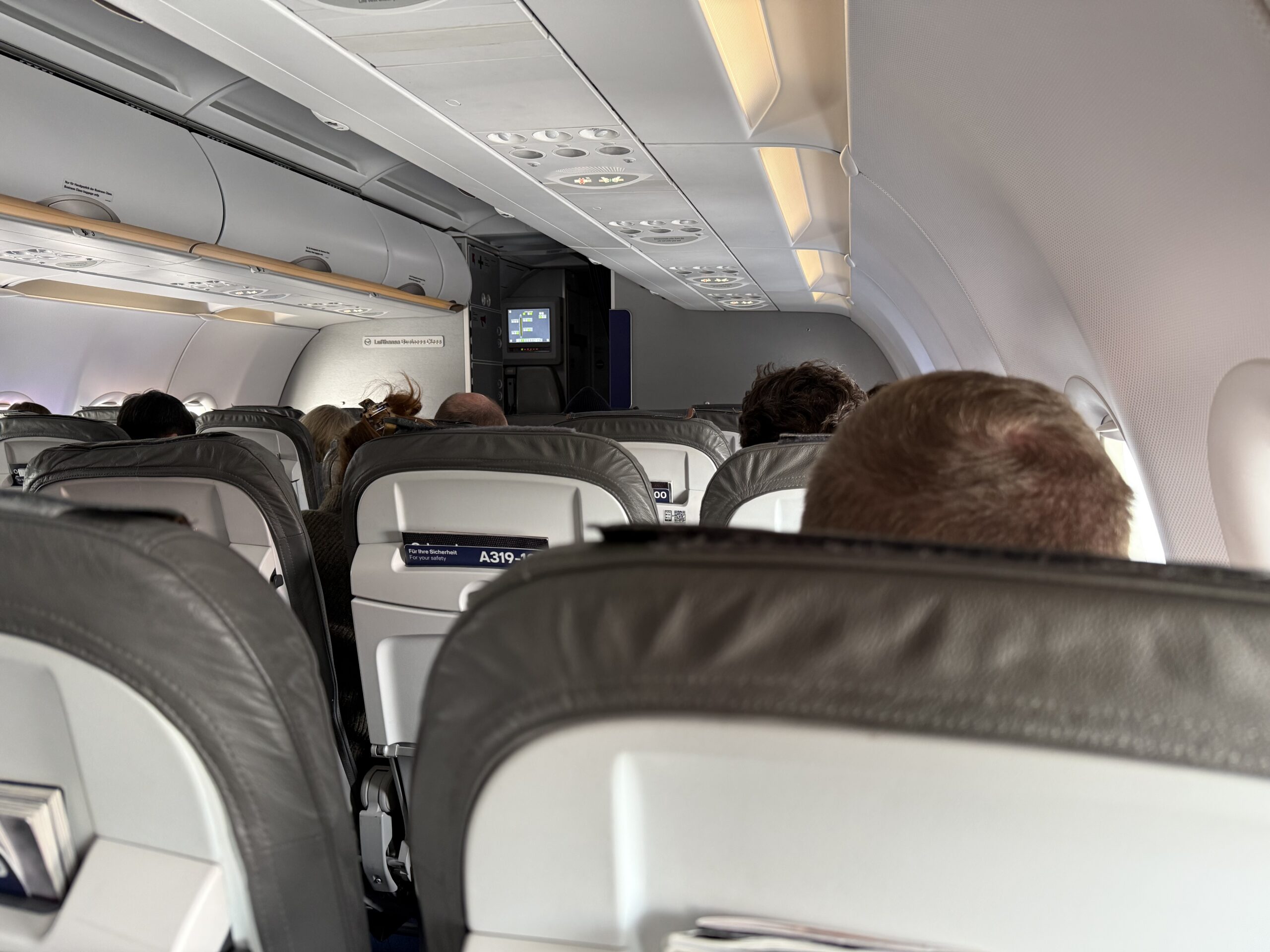 a group of people sitting in an airplane