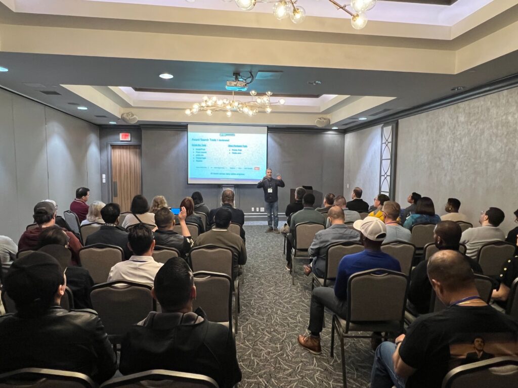 a man standing in front of a group of people in a room