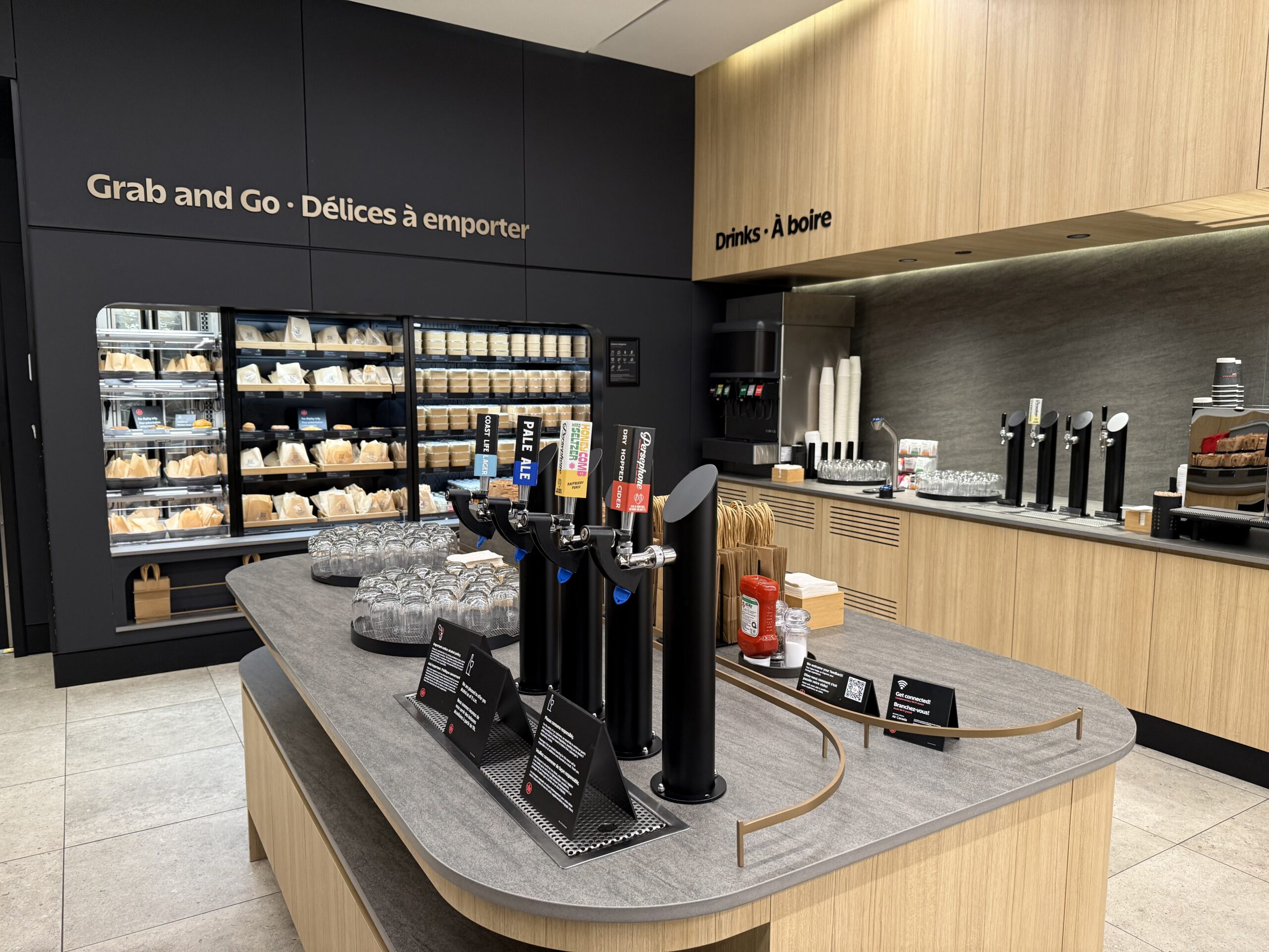 Air Canada Cafe YVR C47 a counter with a variety of drinks on it