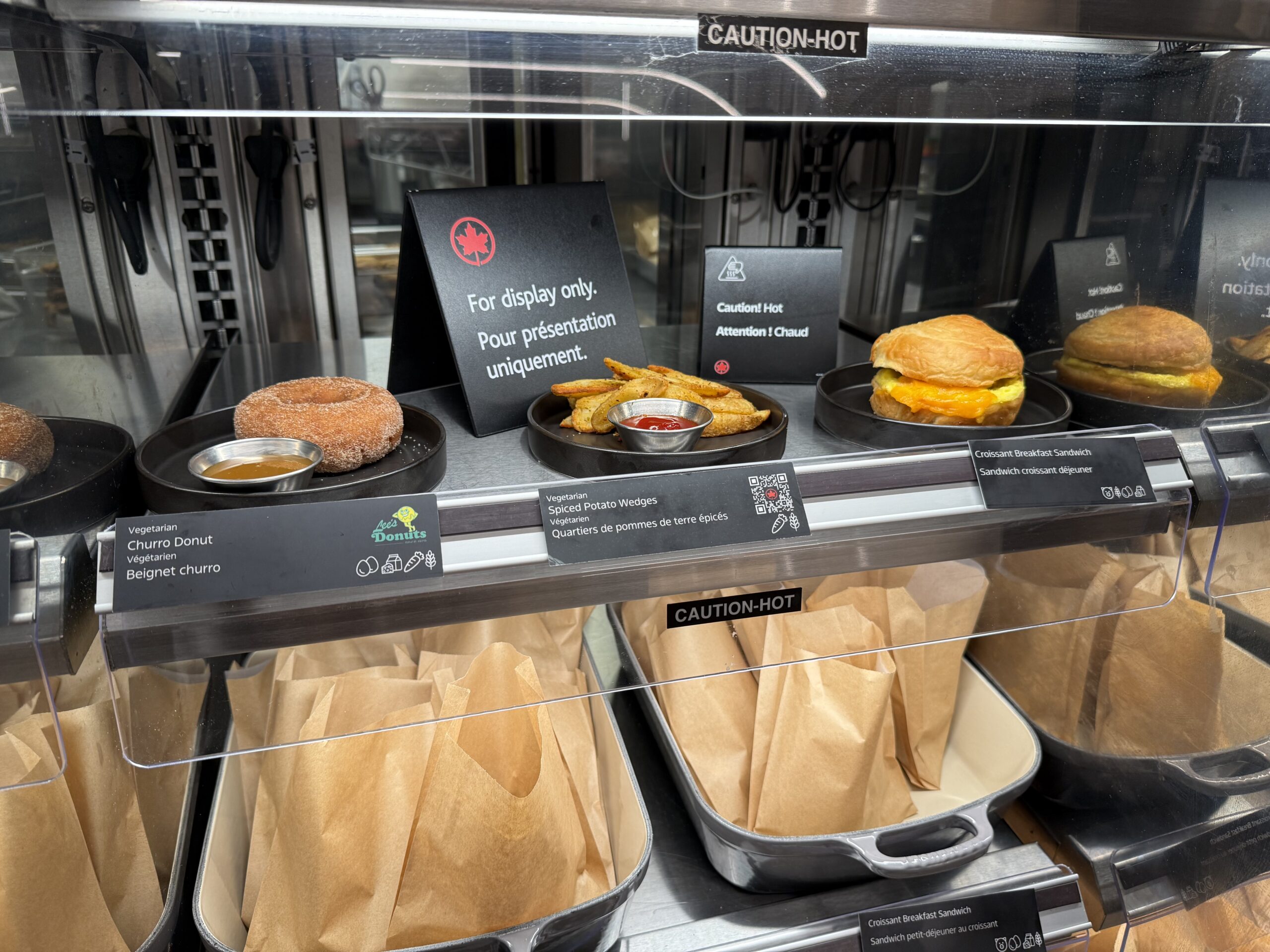 Air Canada Cafe YVR C47 a display case with food on it