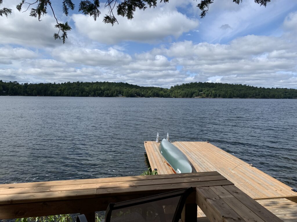 a boat on a dock overlooking a lake