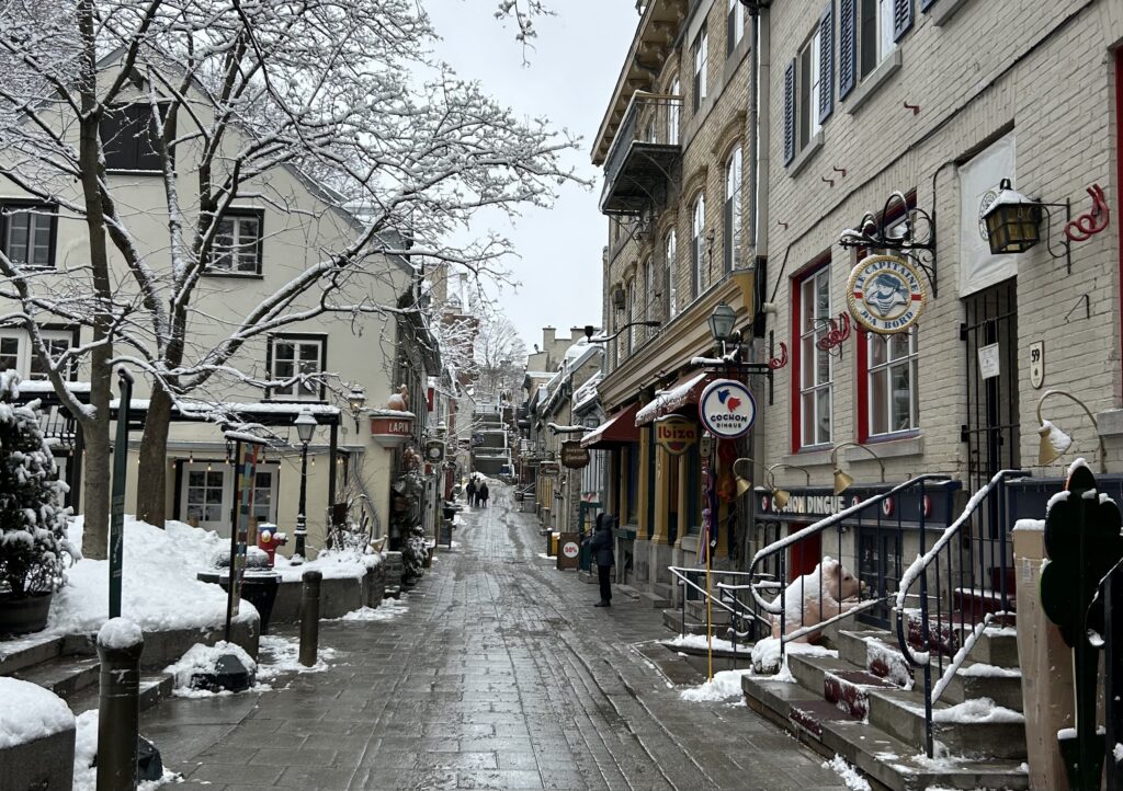 a street with buildings and snow on the ground