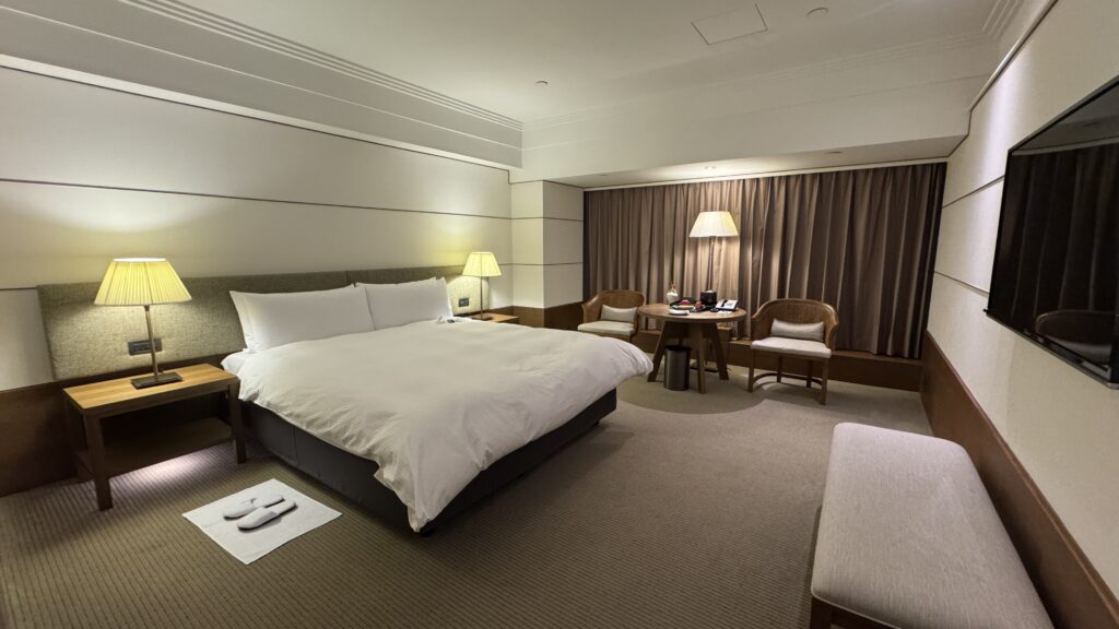 a bedroom with a bed and chairs