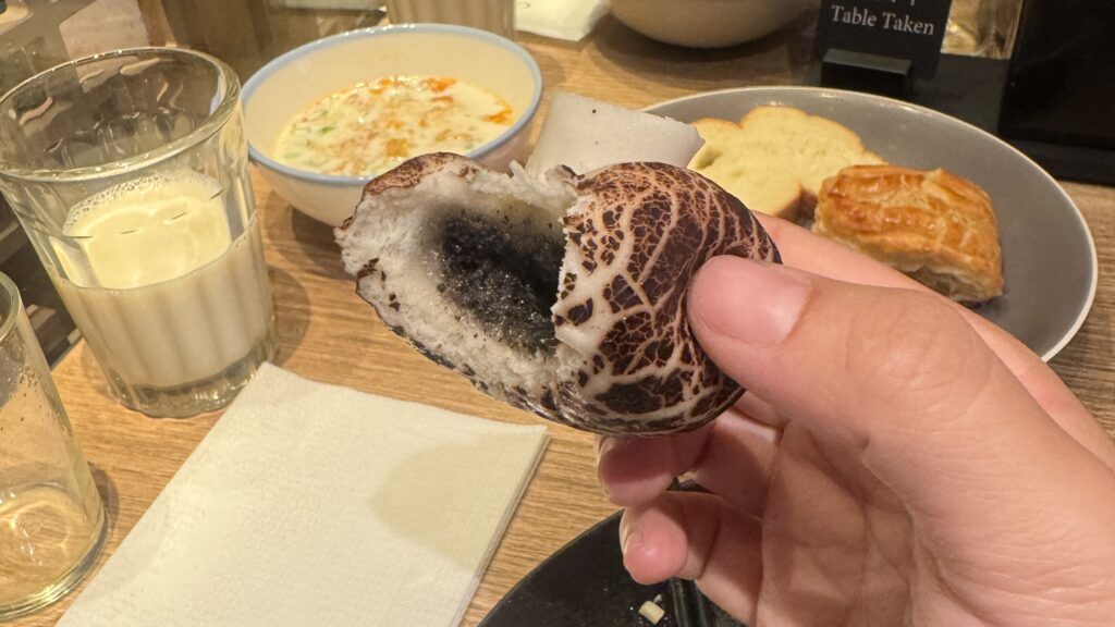 a hand holding a piece of bread