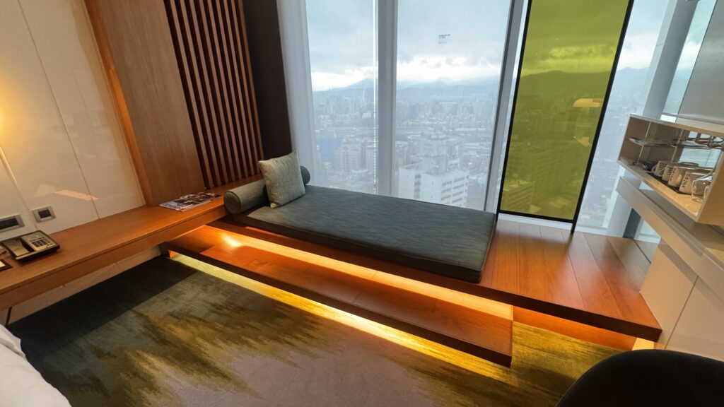 a couch in a room with a window and city view