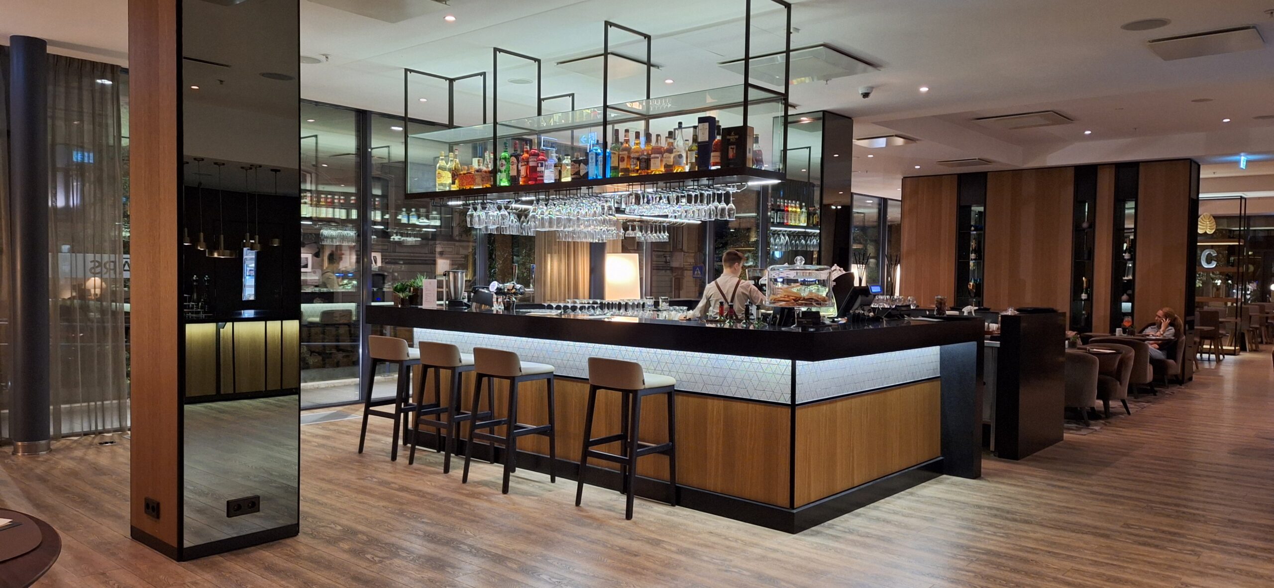 AC Hotel Riga by Marriott Review a bar with a counter and bar stools