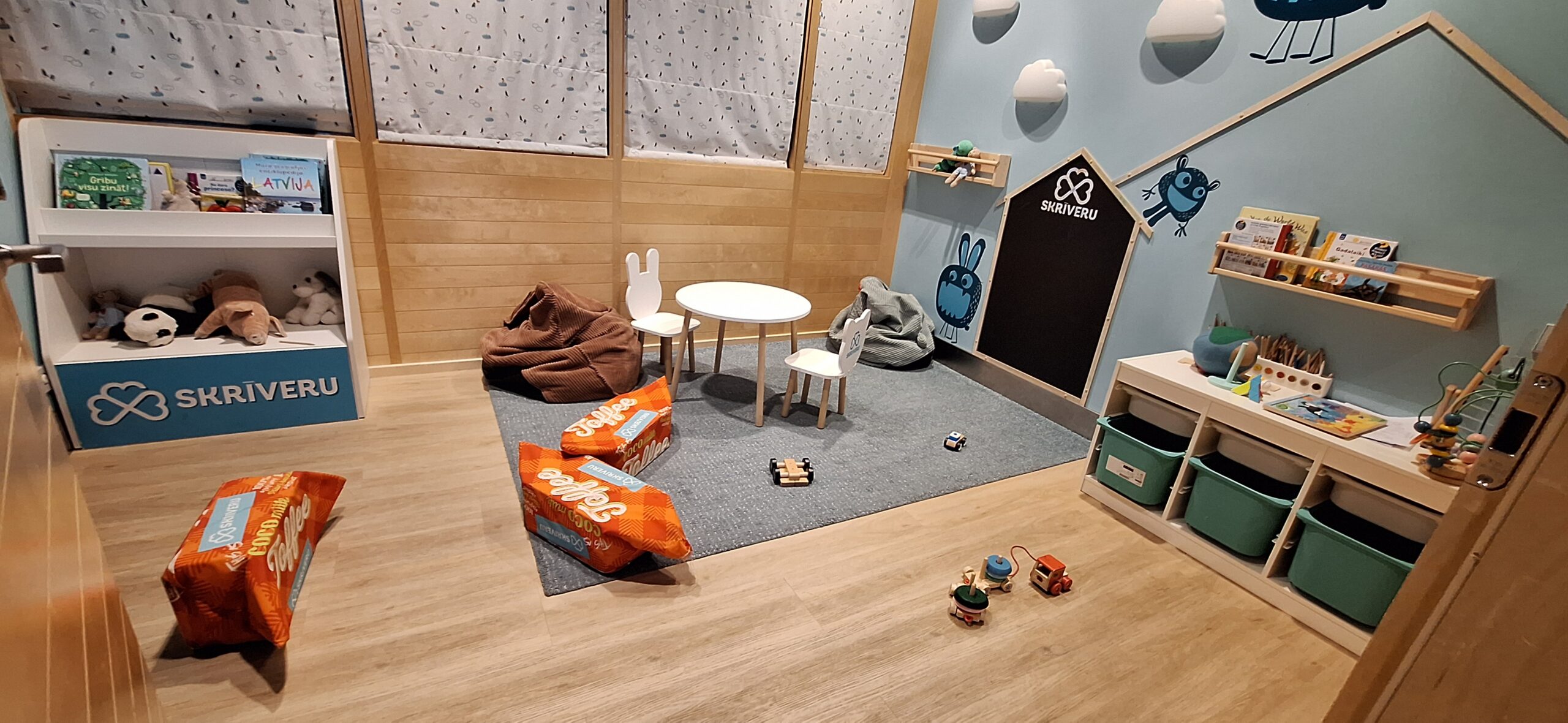 a room with a table and chairs and toys
