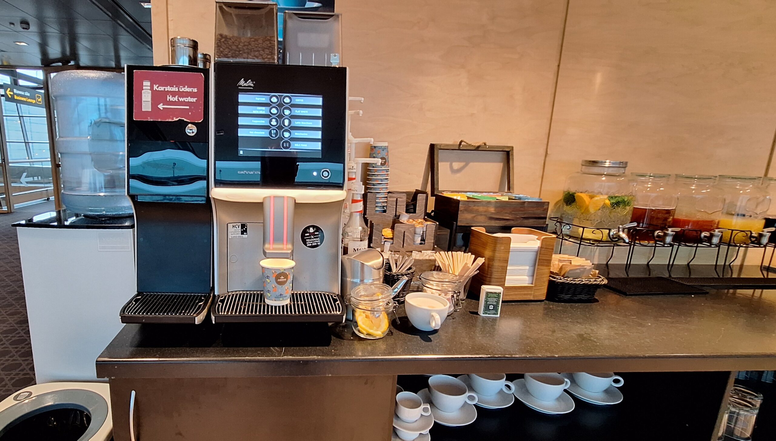 a coffee machine and cups on a counter