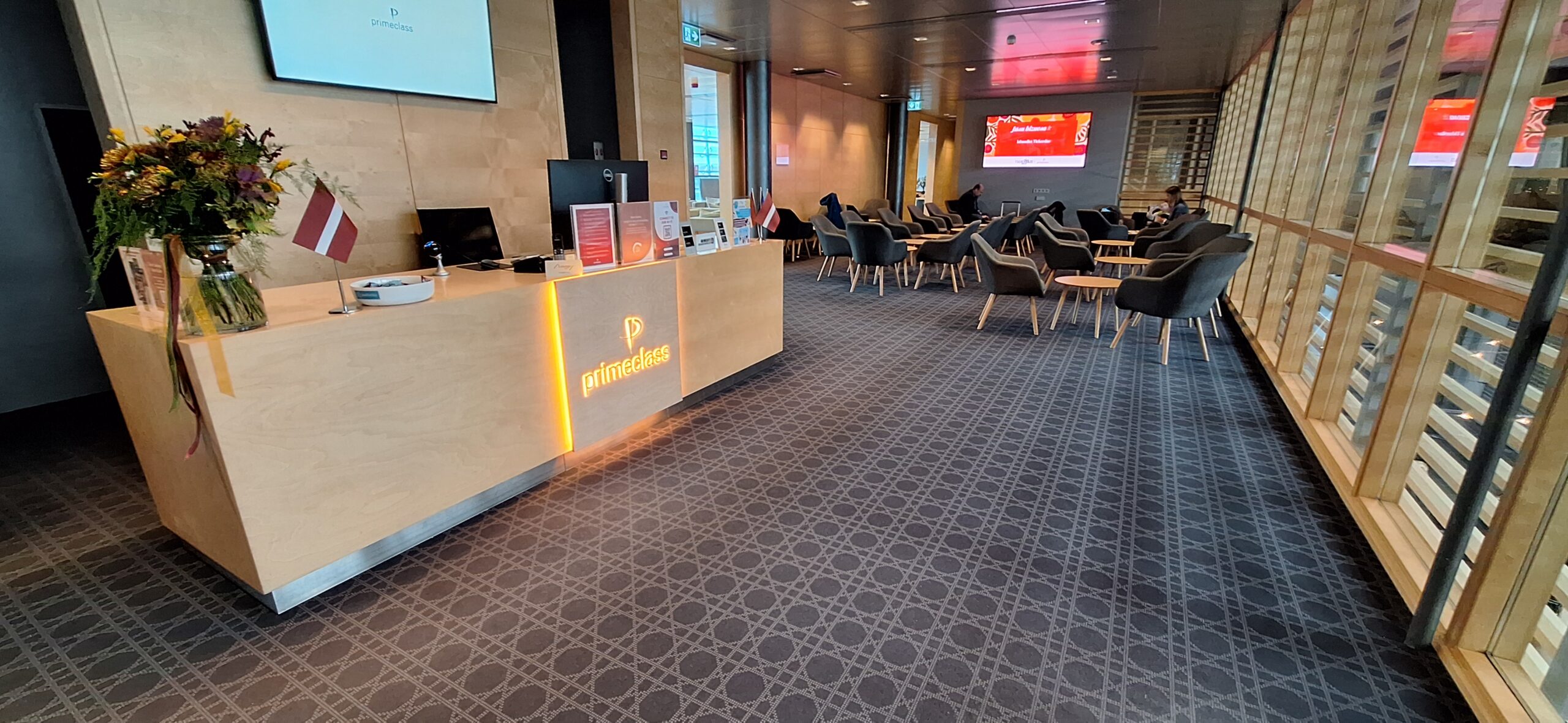 a room with a desk and chairs