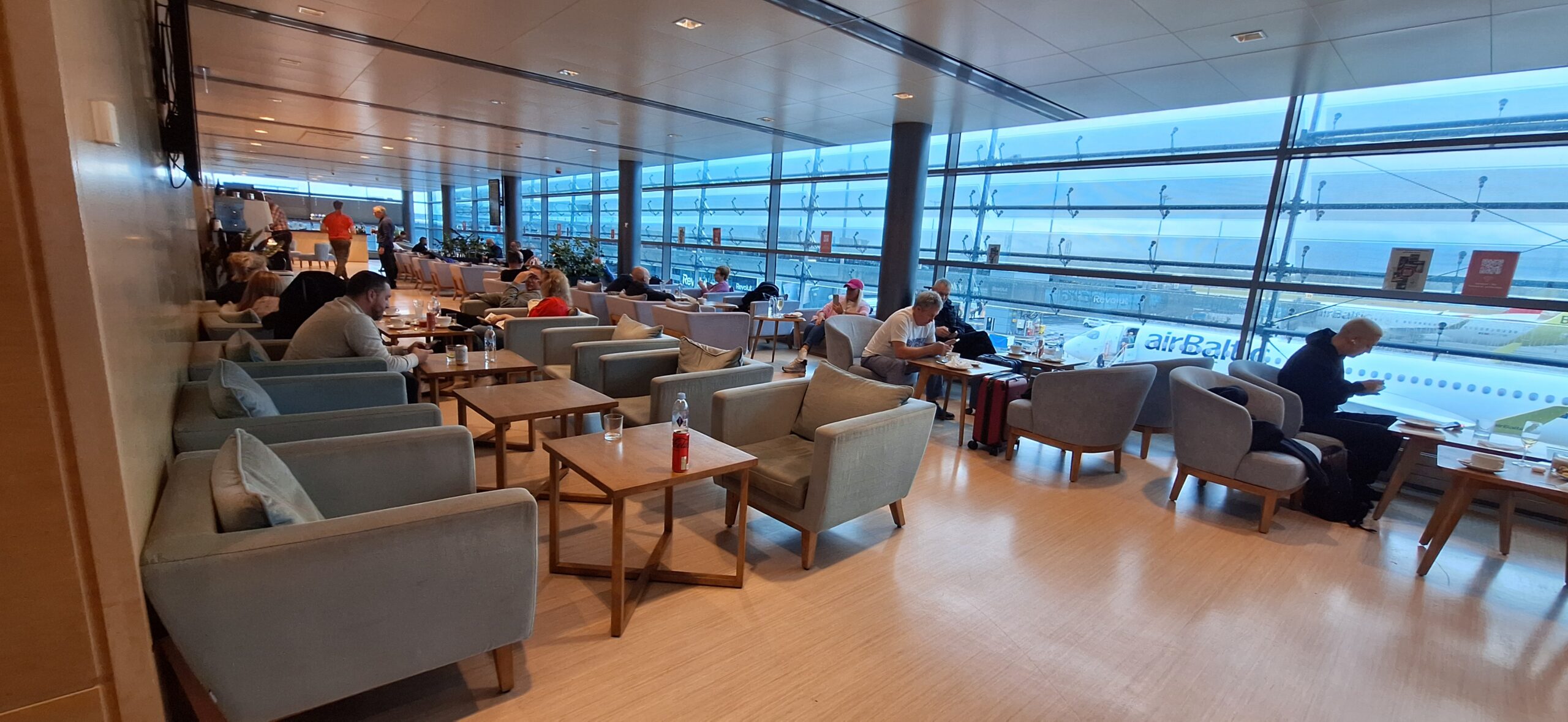 a group of people sitting at tables in a large room