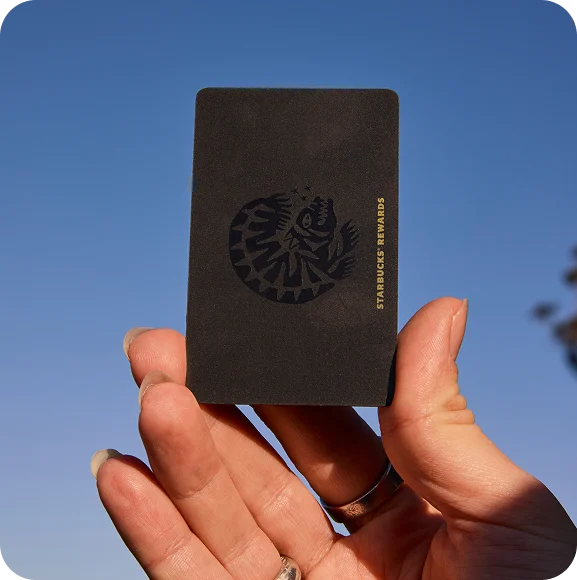 a hand holding a black card
