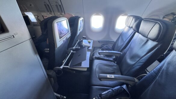 a laptop on a table in an airplane
