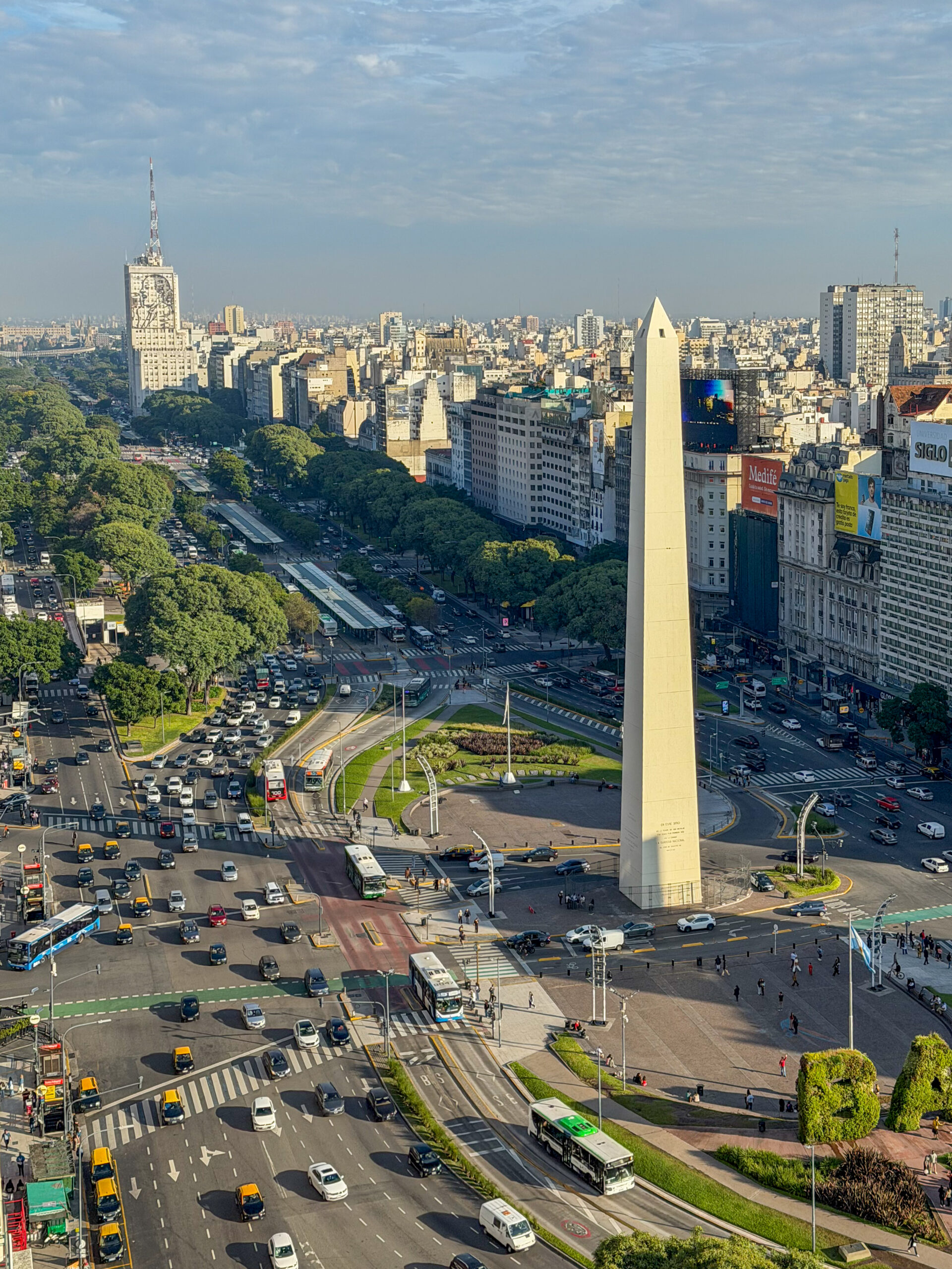 a large white obelisk in a city