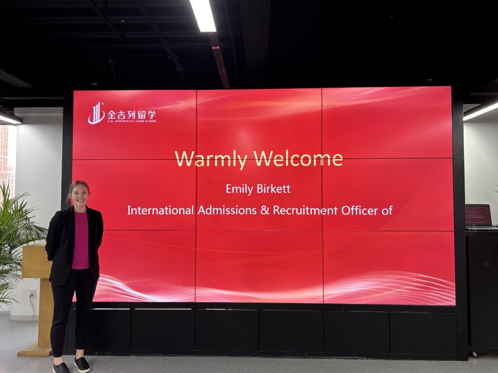 What to Know about Cultural Greetings a woman standing in front of a large screen