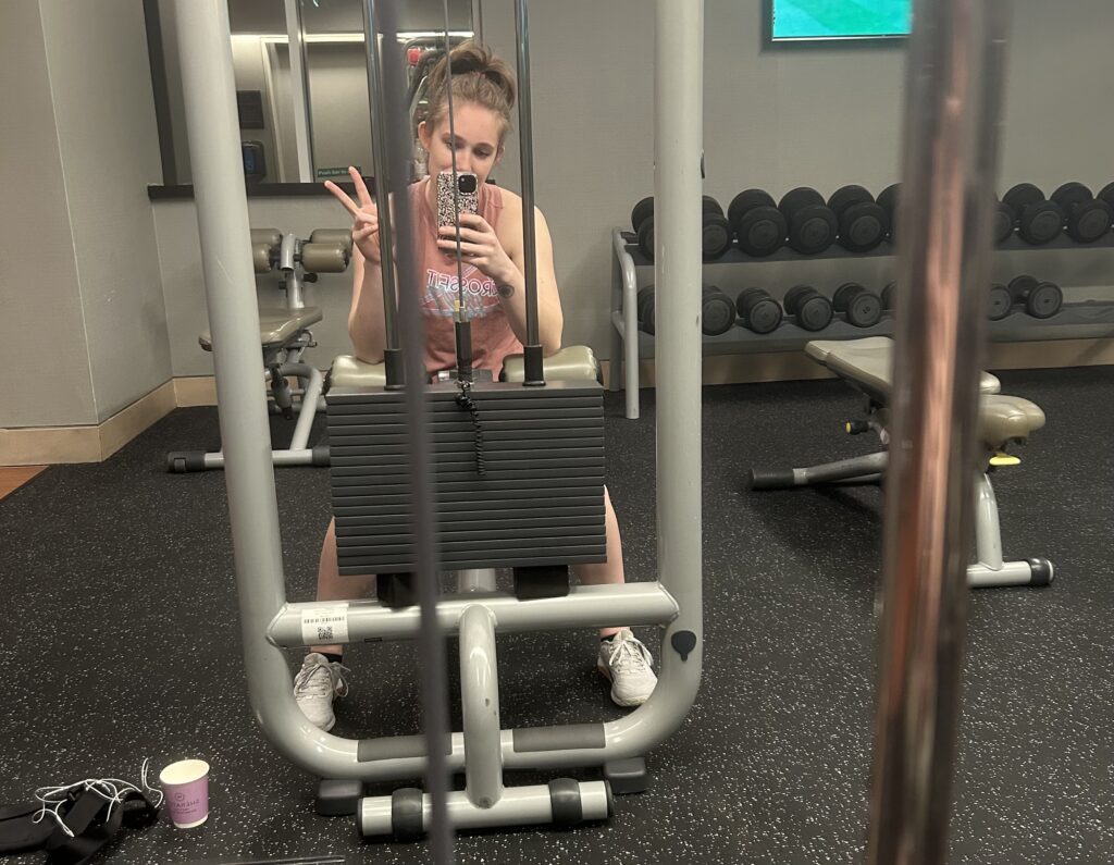 a woman taking a selfie in a gym