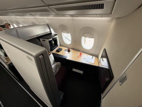 a small table with a tv and a television on the side of the plane