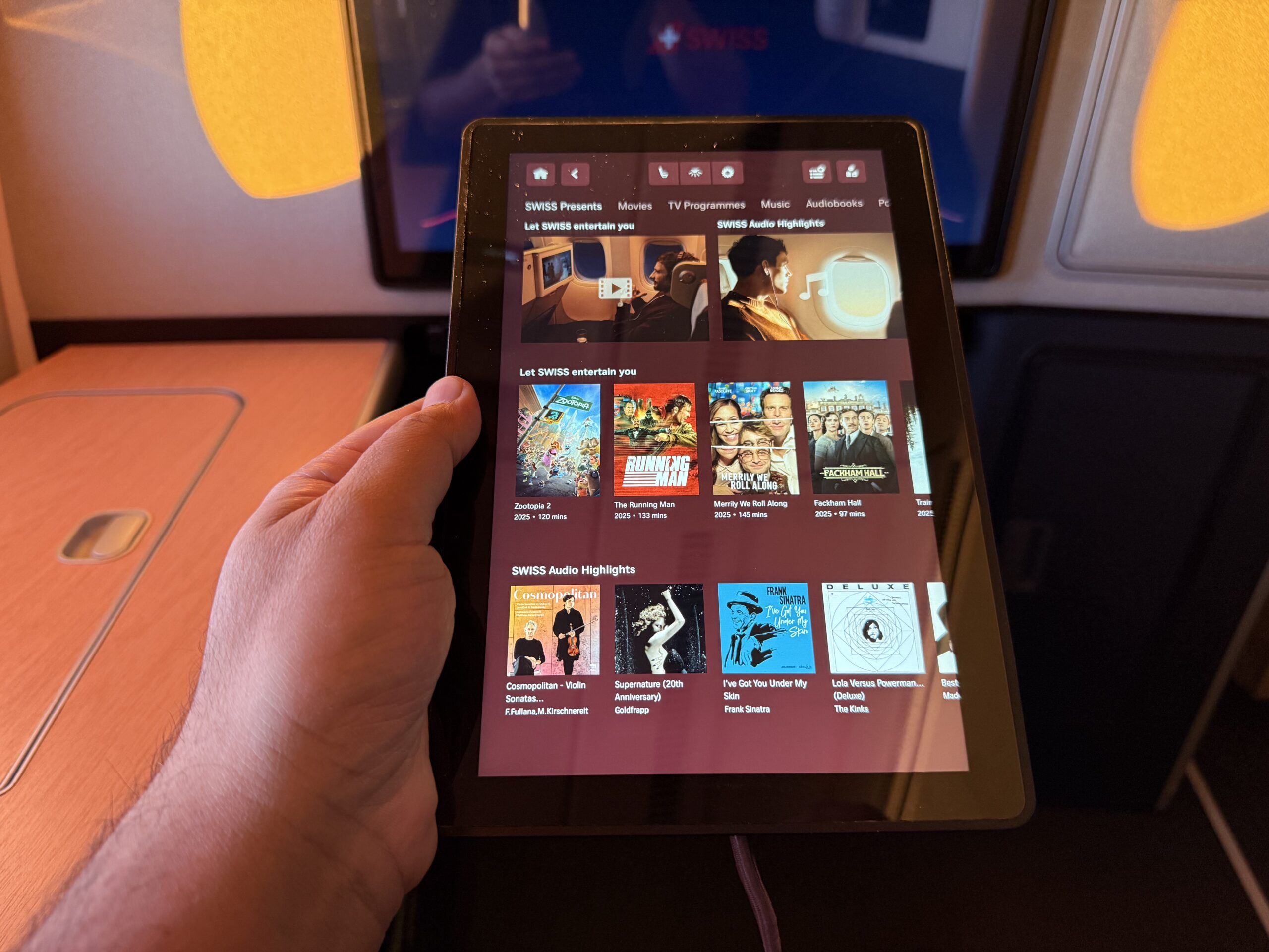 a hand holding a tablet