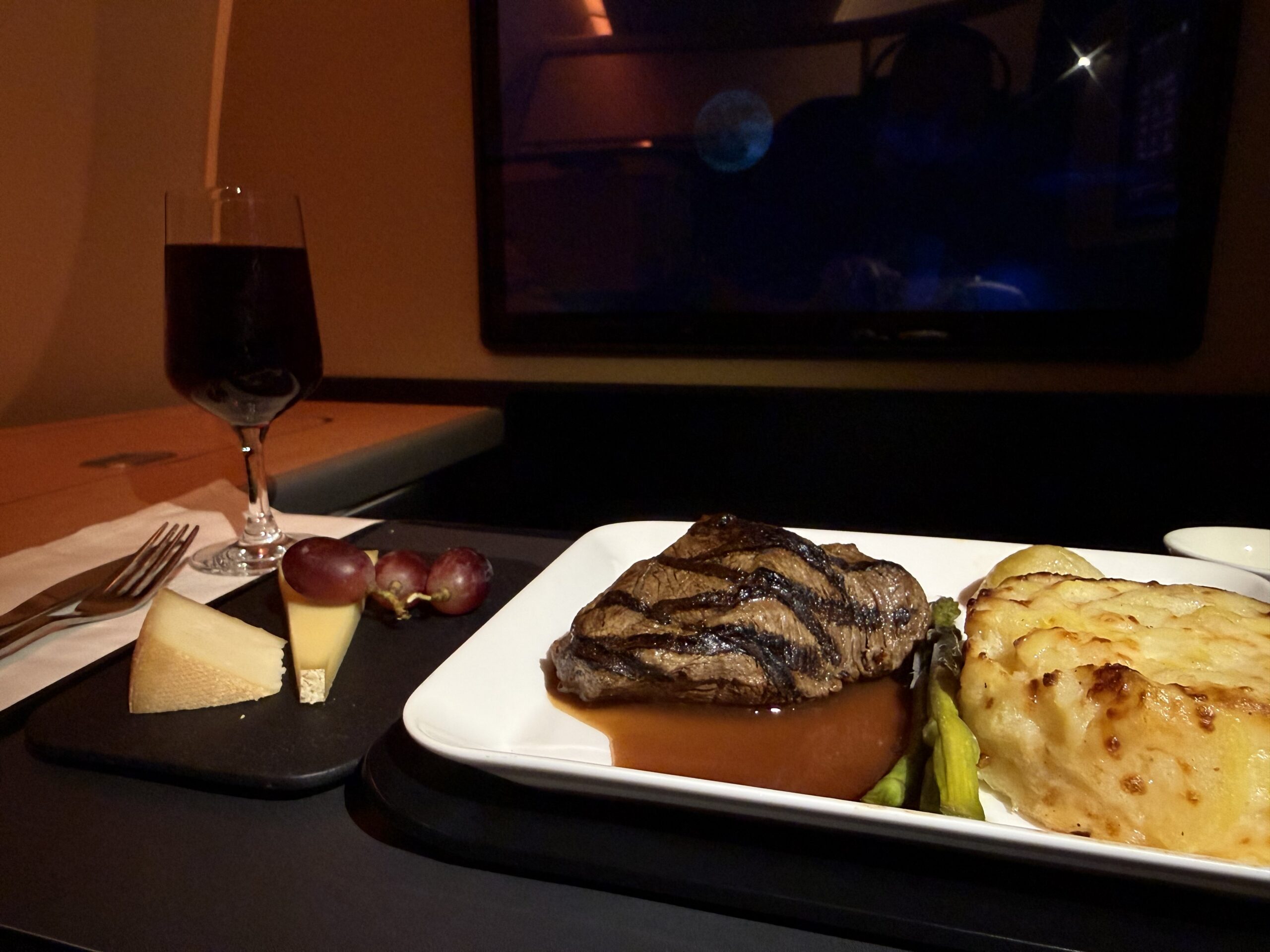 a plate of food and a glass of wine