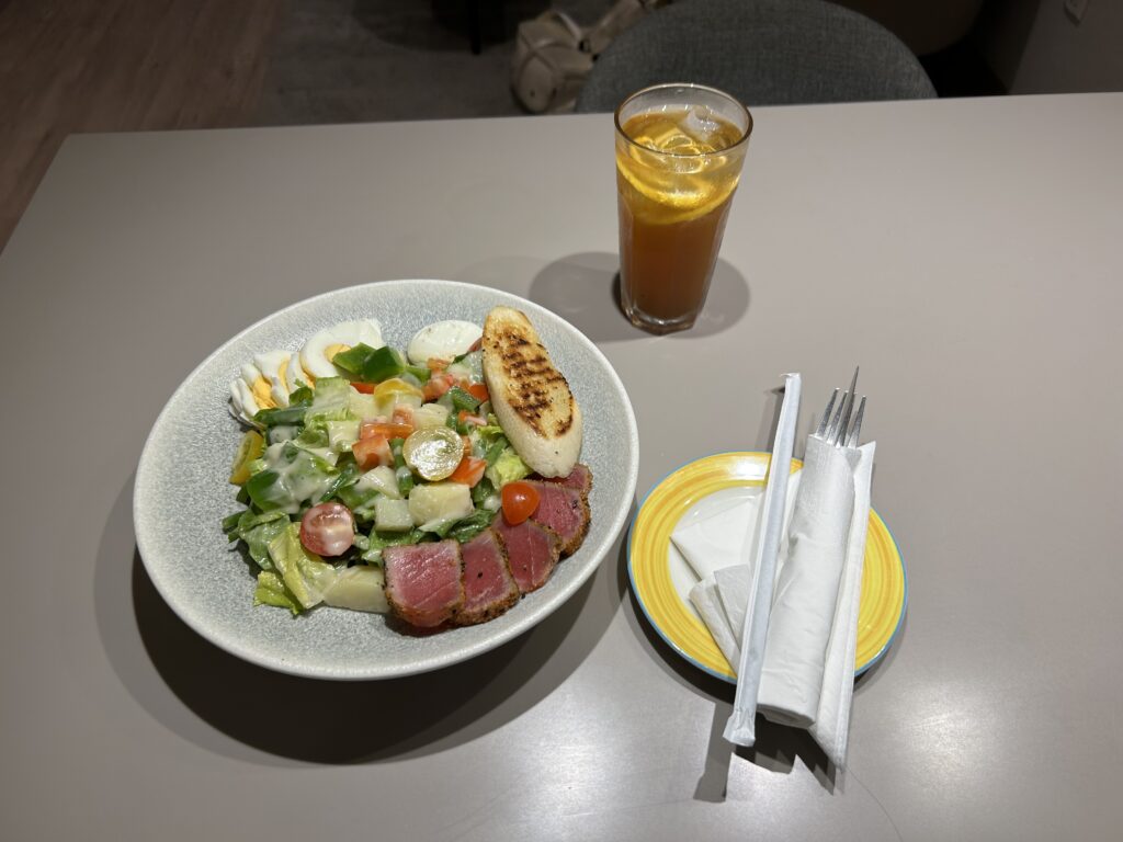 a plate of salad and a glass of juice