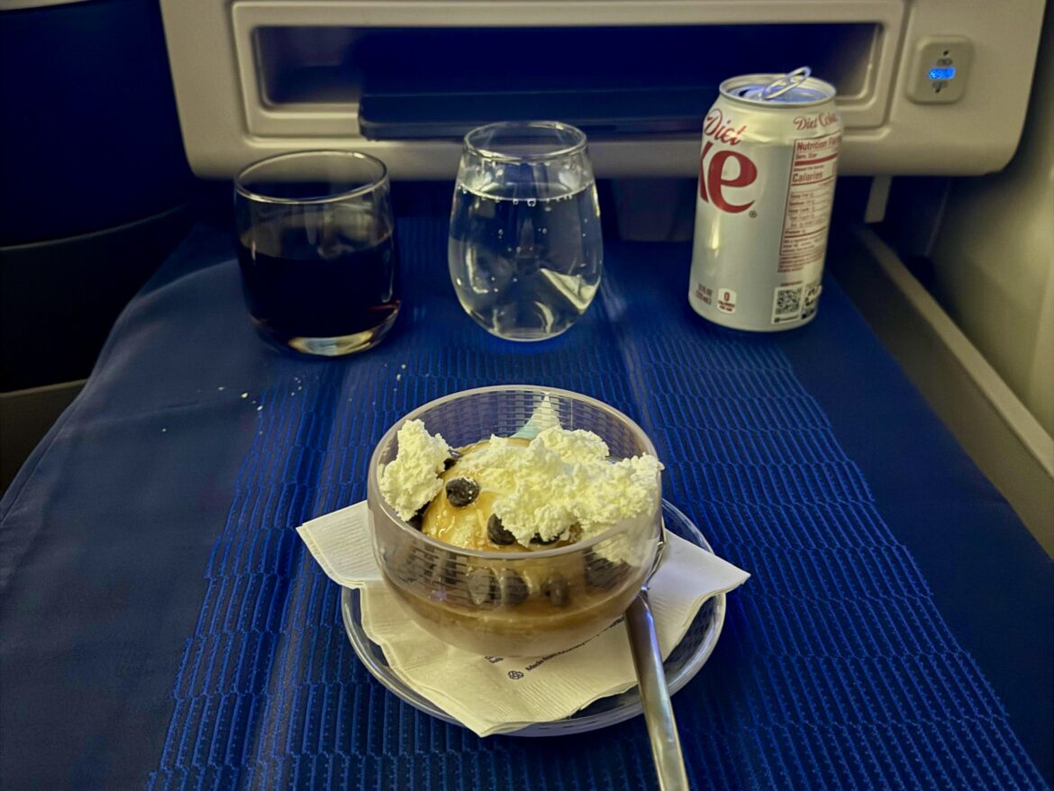 a dessert on a plate with a can of soda and a can of soda
