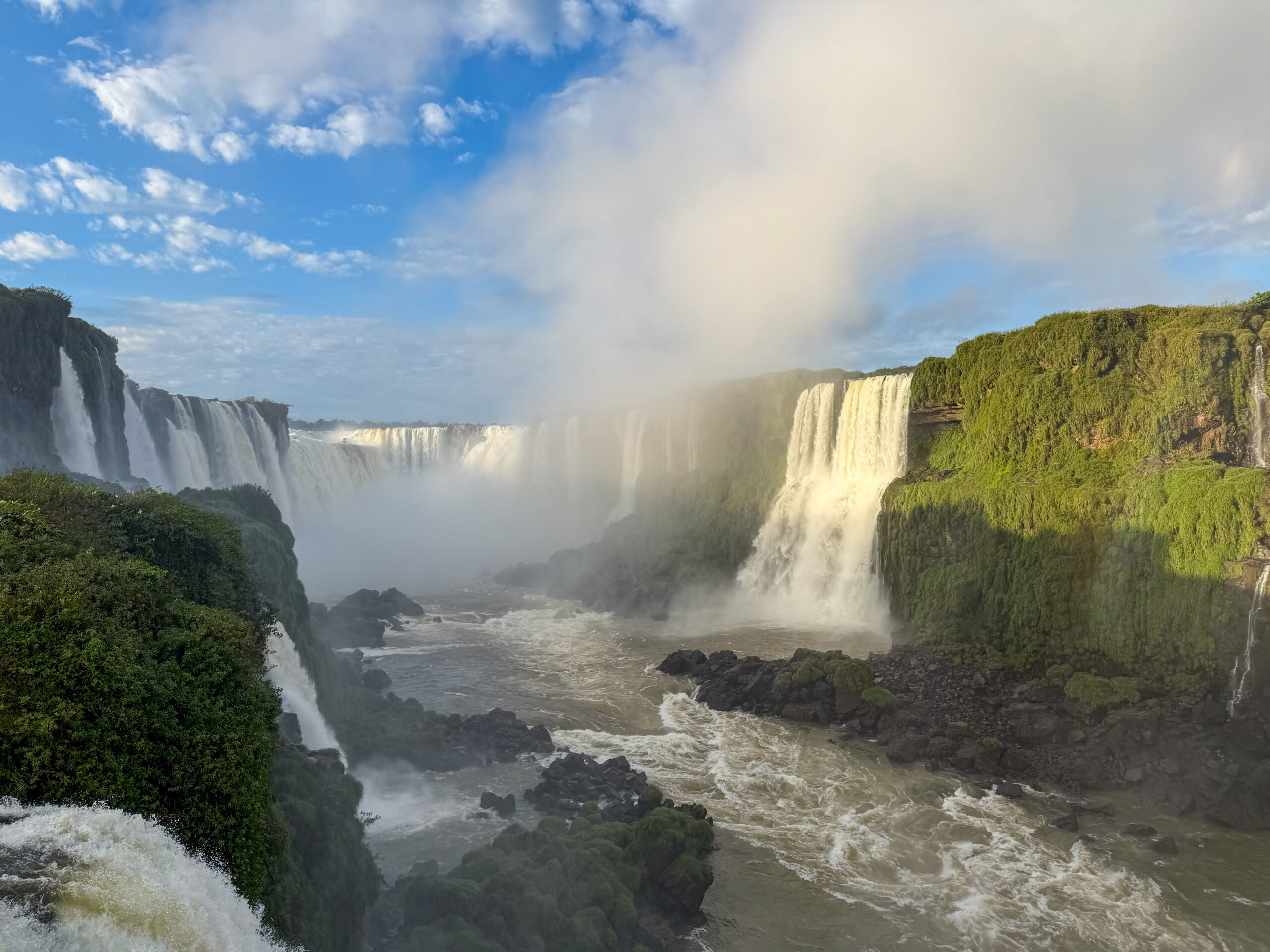 a large waterfall with a body of water