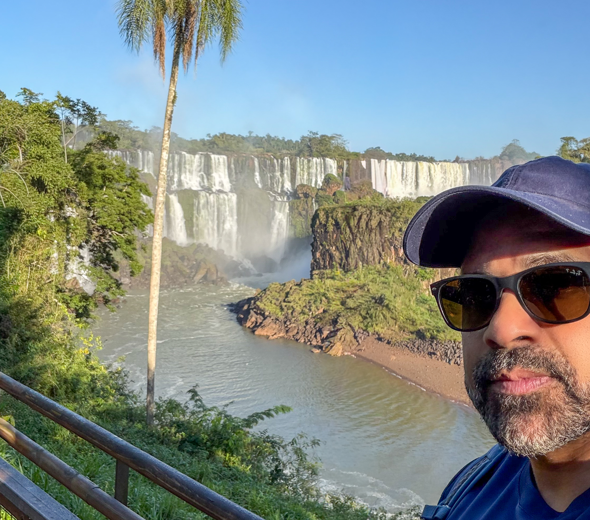 a man taking a selfie with a waterfall
