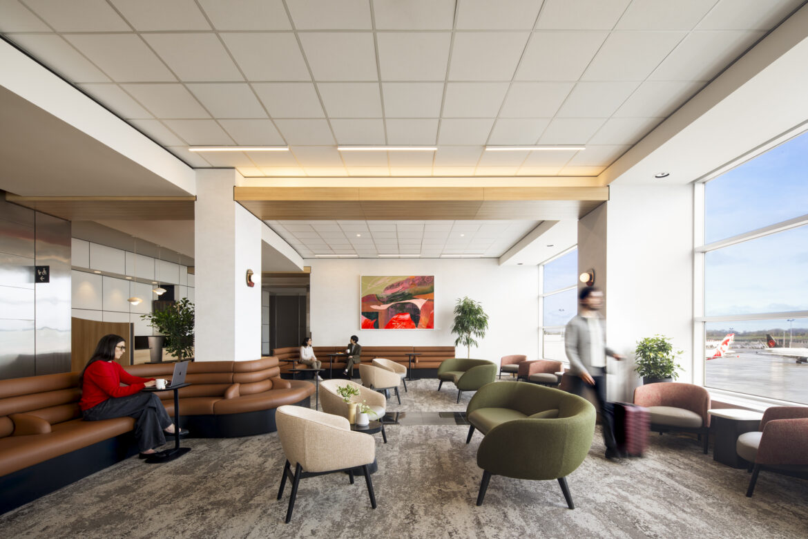 a room with a large couch and chairs