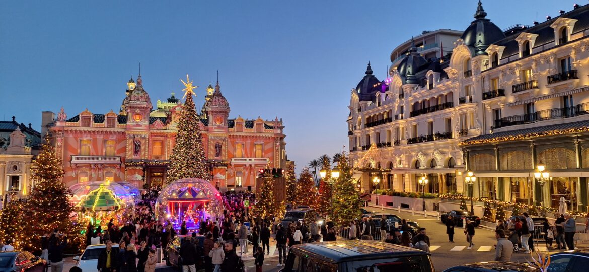 a group of people in front of a building with christmas lights
