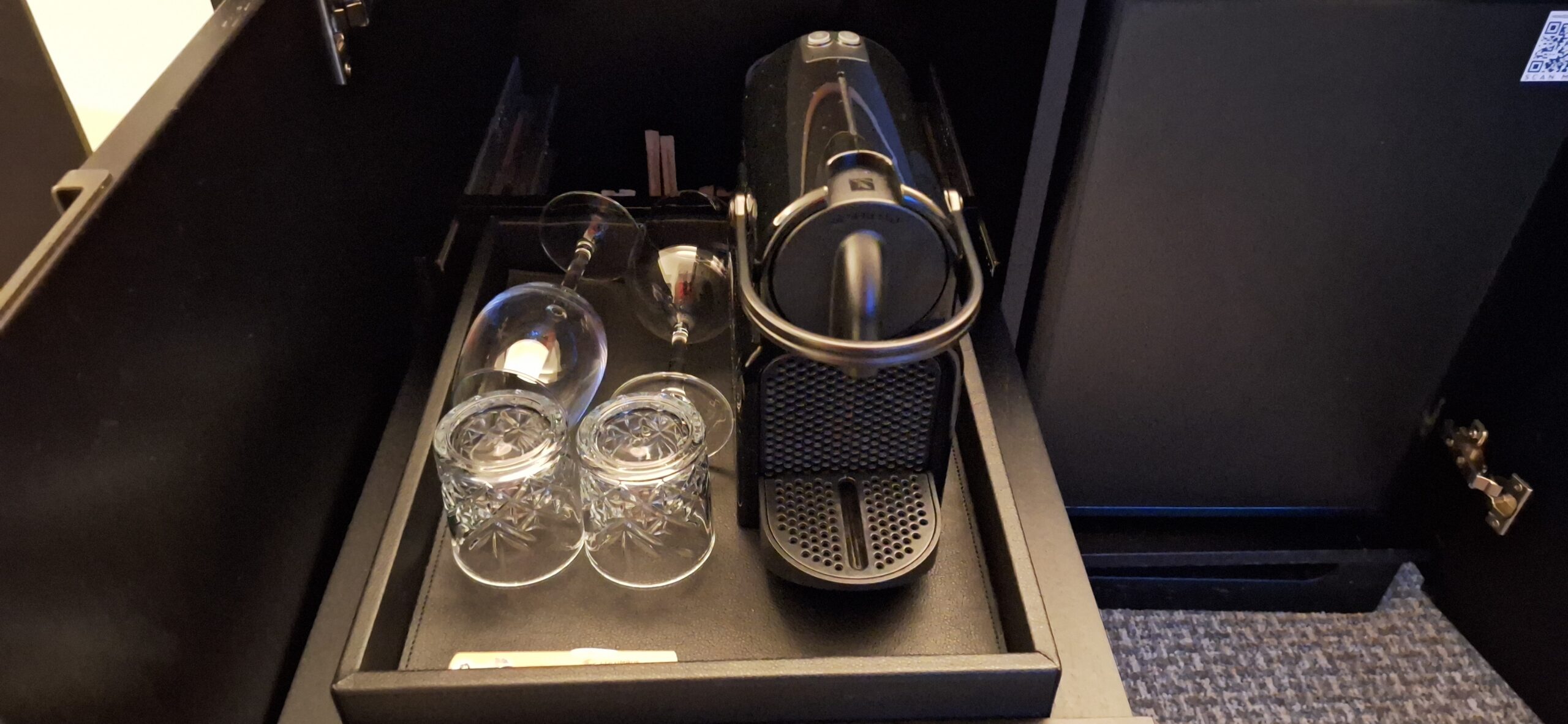 a wine glasses and a machine on a tray