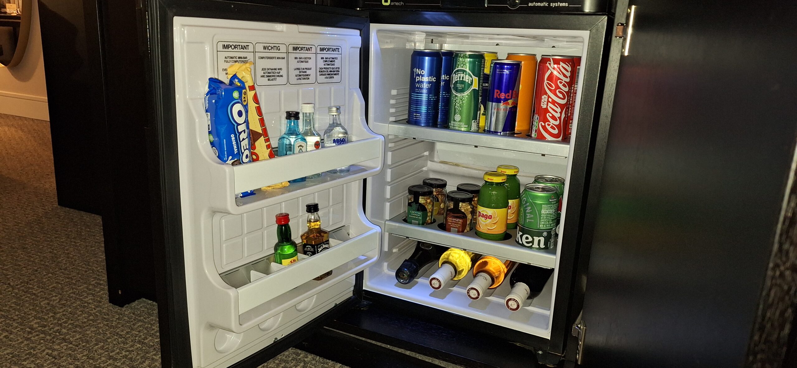a mini fridge with drinks and snacks