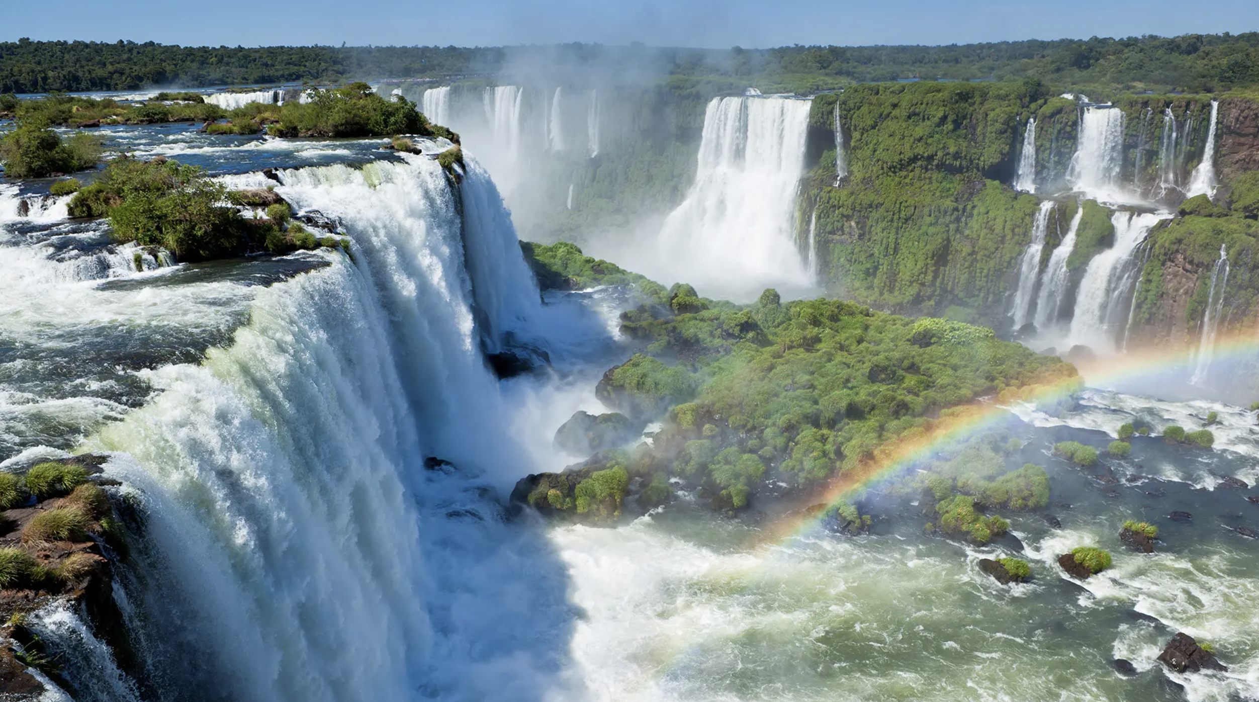 a large waterfall with a rainbow