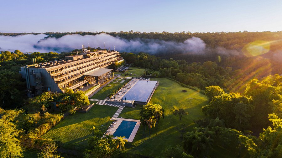 a building with a pool and trees