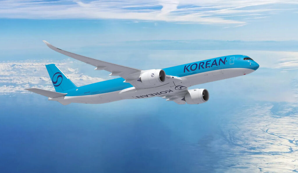 a blue and white airplane flying in the sky