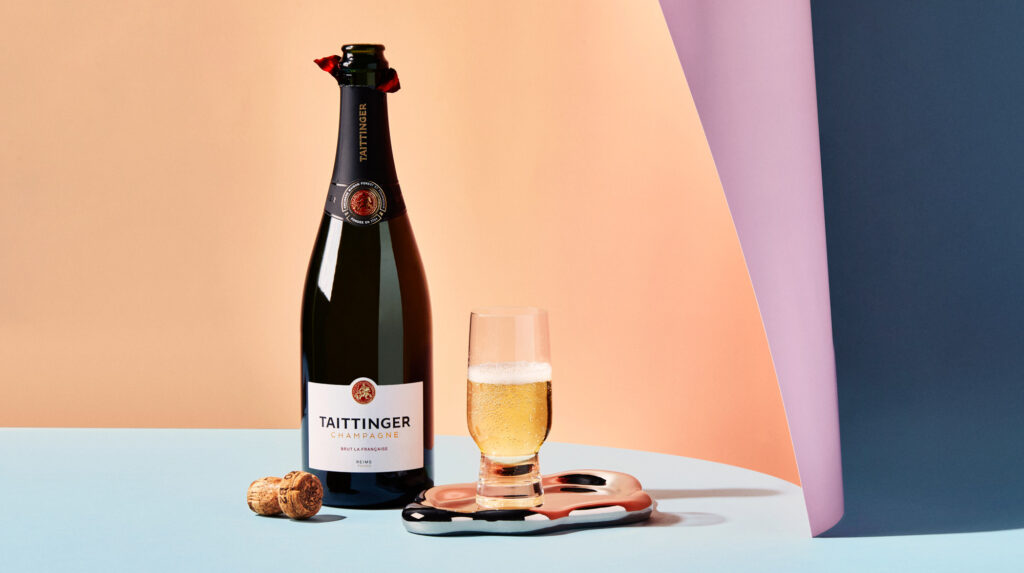 a bottle of champagne next to a glass of champagne
