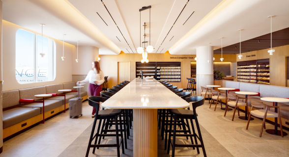 a long table with chairs and a woman in the background