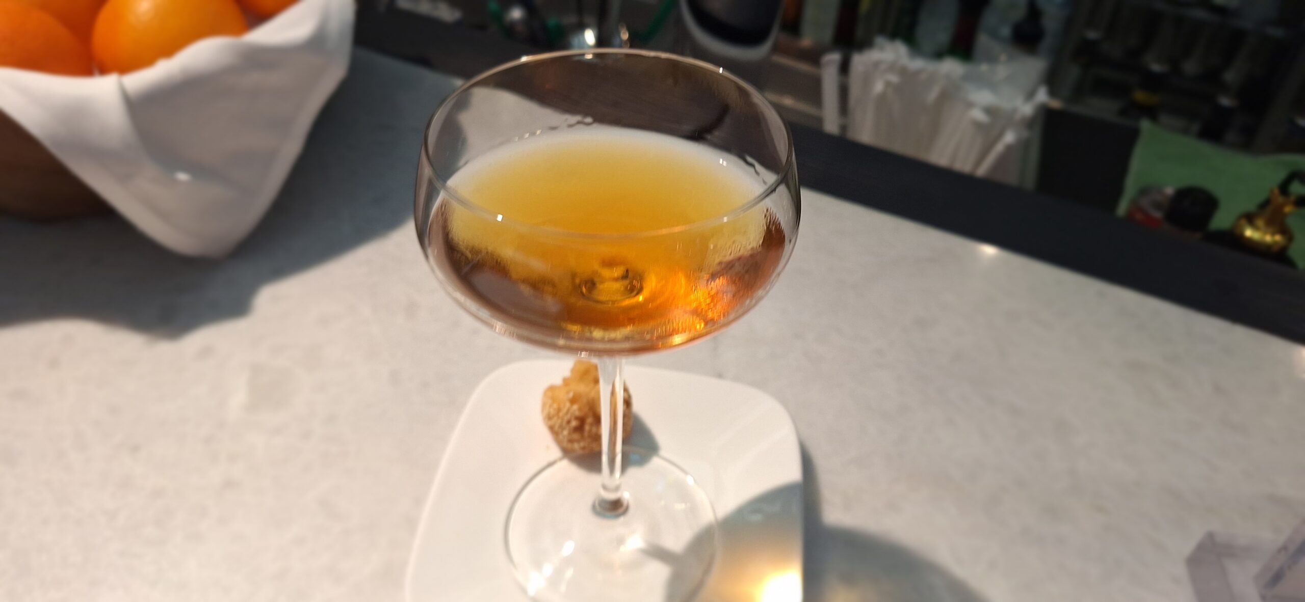 Centurion Lounge Hong Kong a glass of liquid on a plate