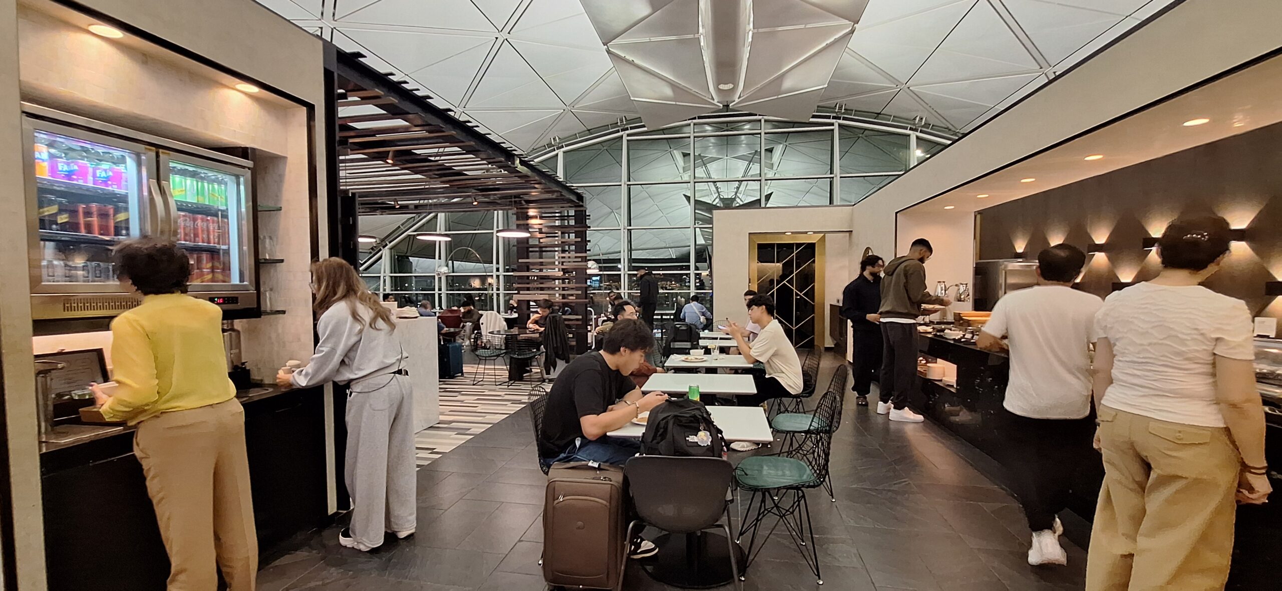 Centurion Lounge Hong Kong people sitting at tables in a room with windows