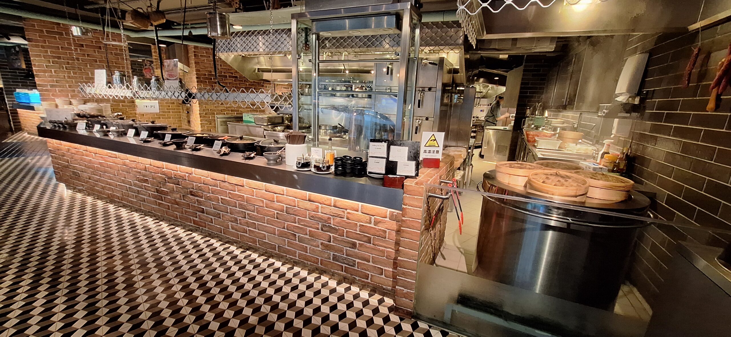 The Park Lane Hong Kong Review a kitchen with a brick wall and a counter
