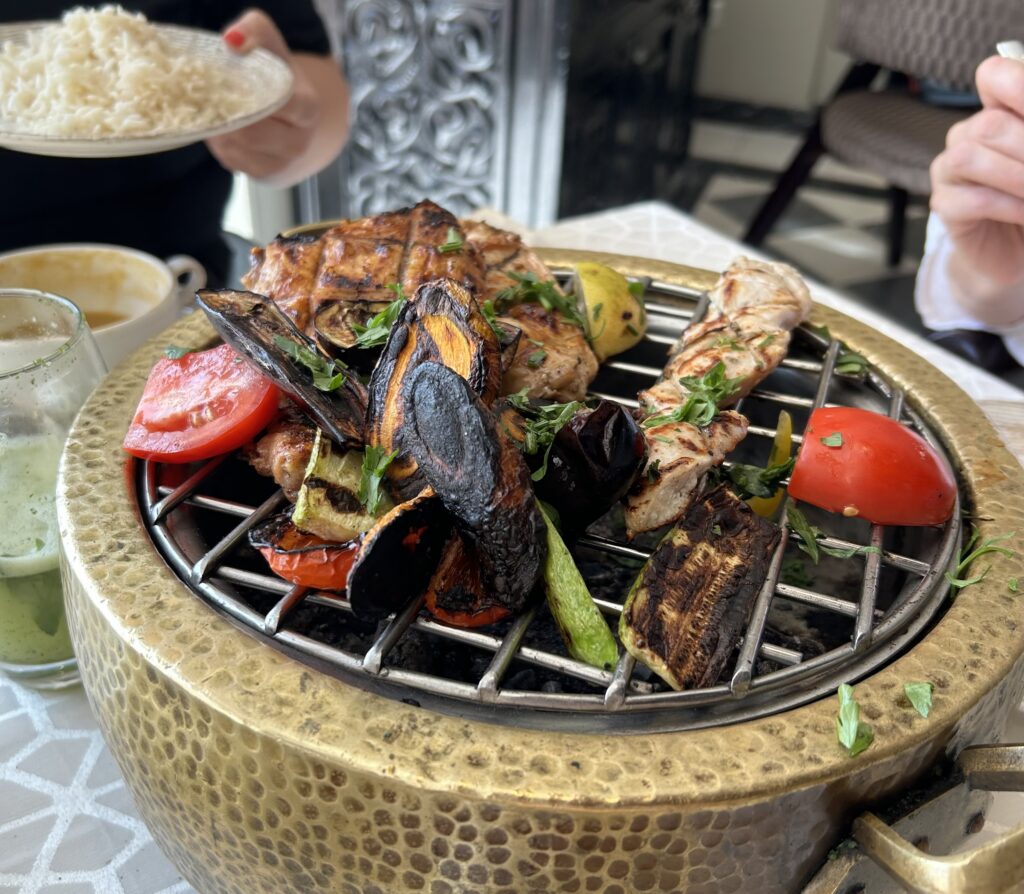 a grill with meat and vegetables on it
