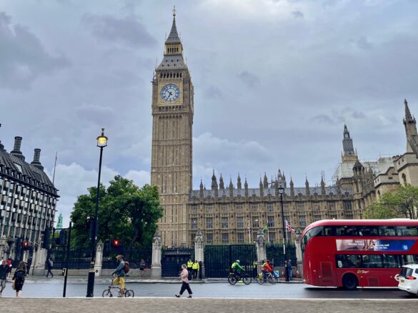 a large clock tower in front of a large building