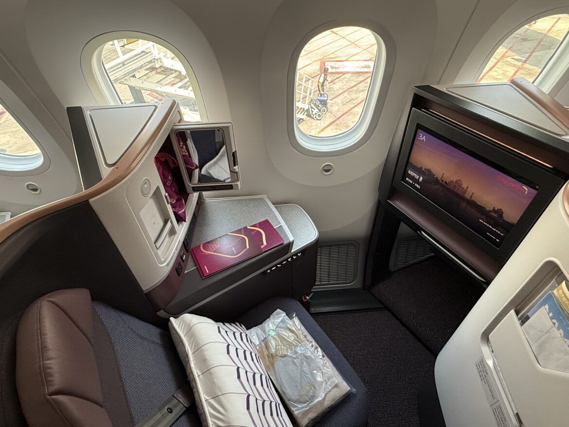 a seat and a television in an airplane