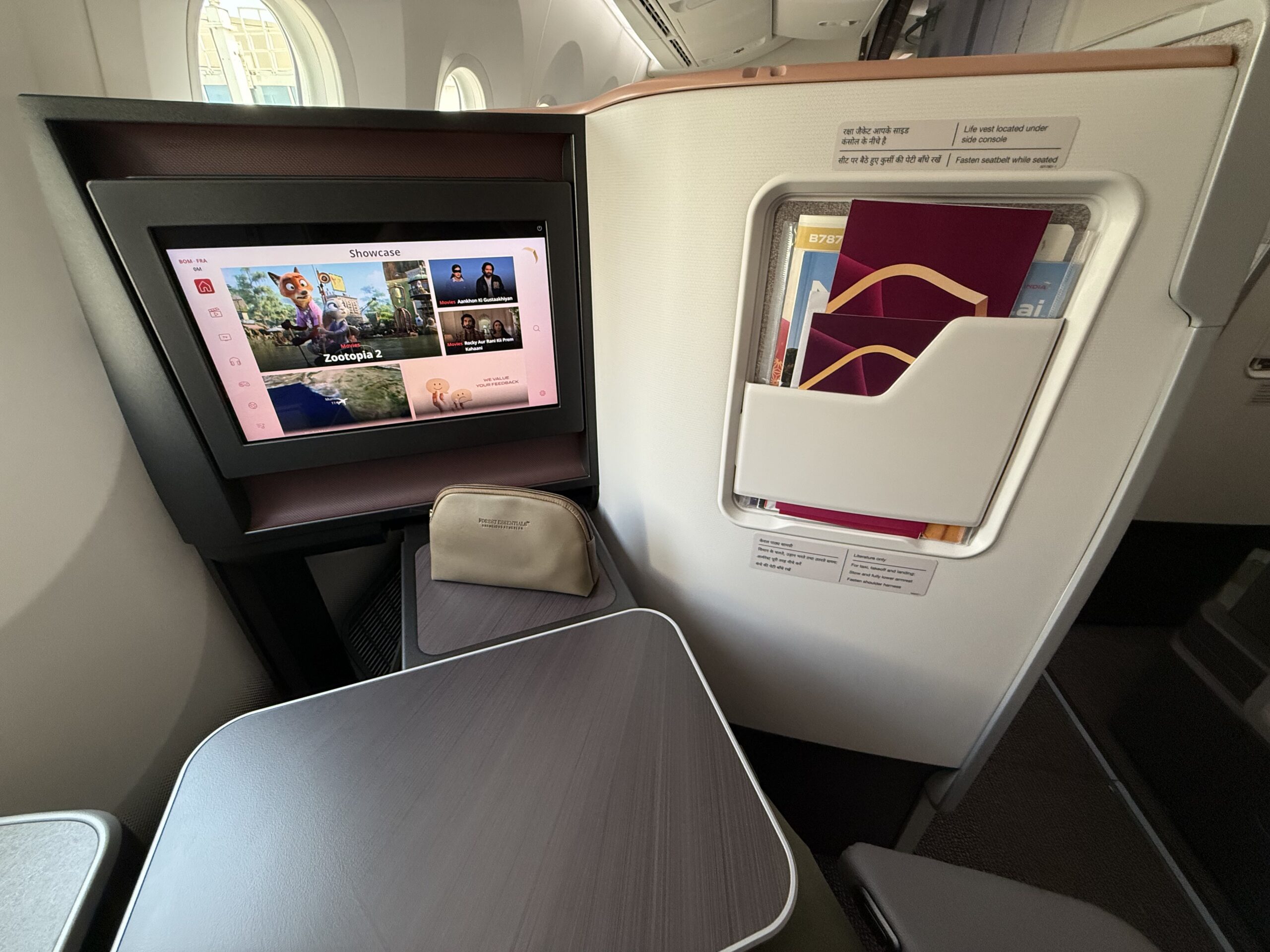 Air India 787-9 Business Class a tv and table in an airplane
