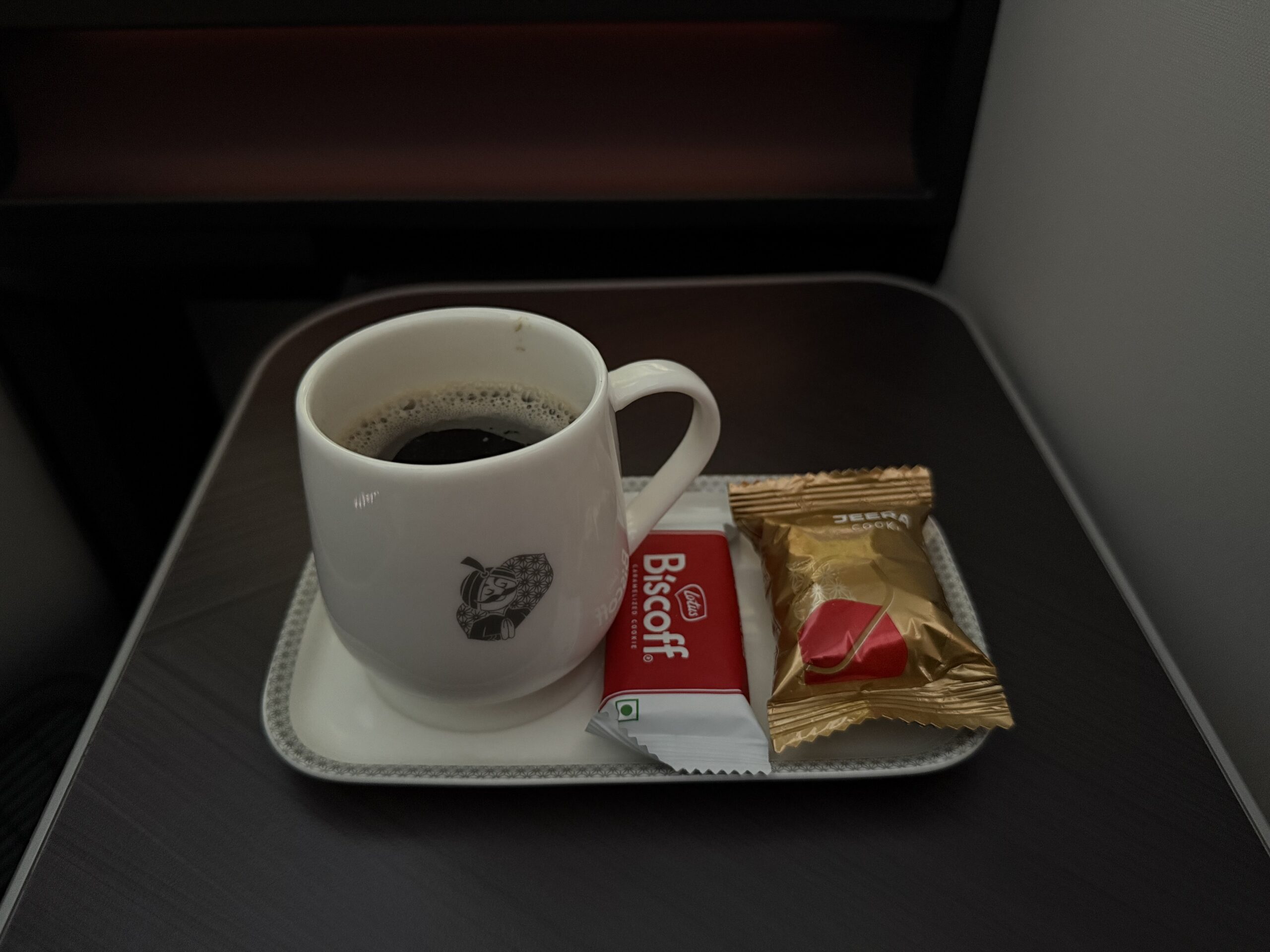 Air India 787-9 Business Class a coffee cup and candy on a tray
